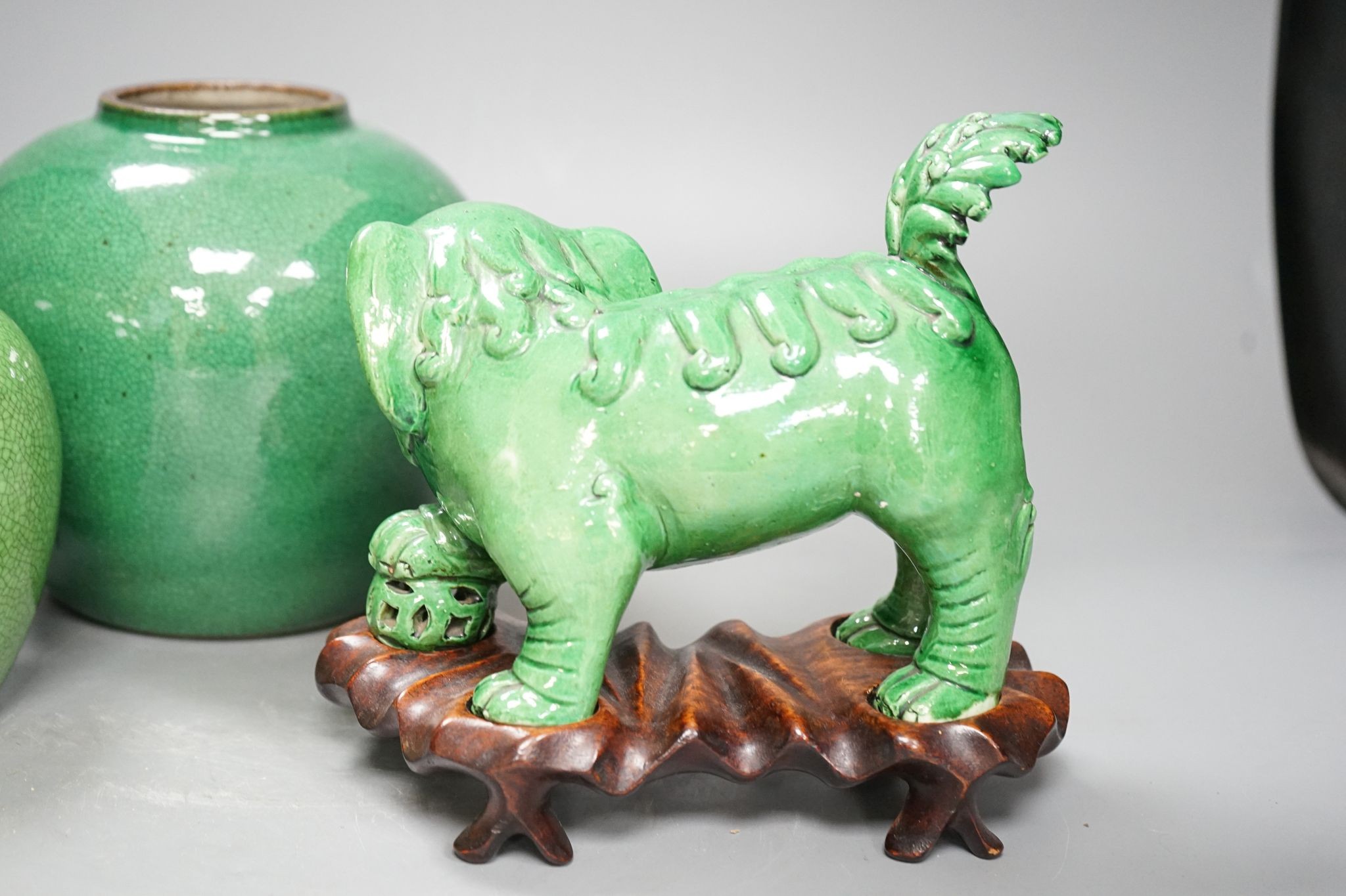 A 19th century Chinese green glazed model of a lion-dog, and two green crackle glaze jars, tallest 16cm